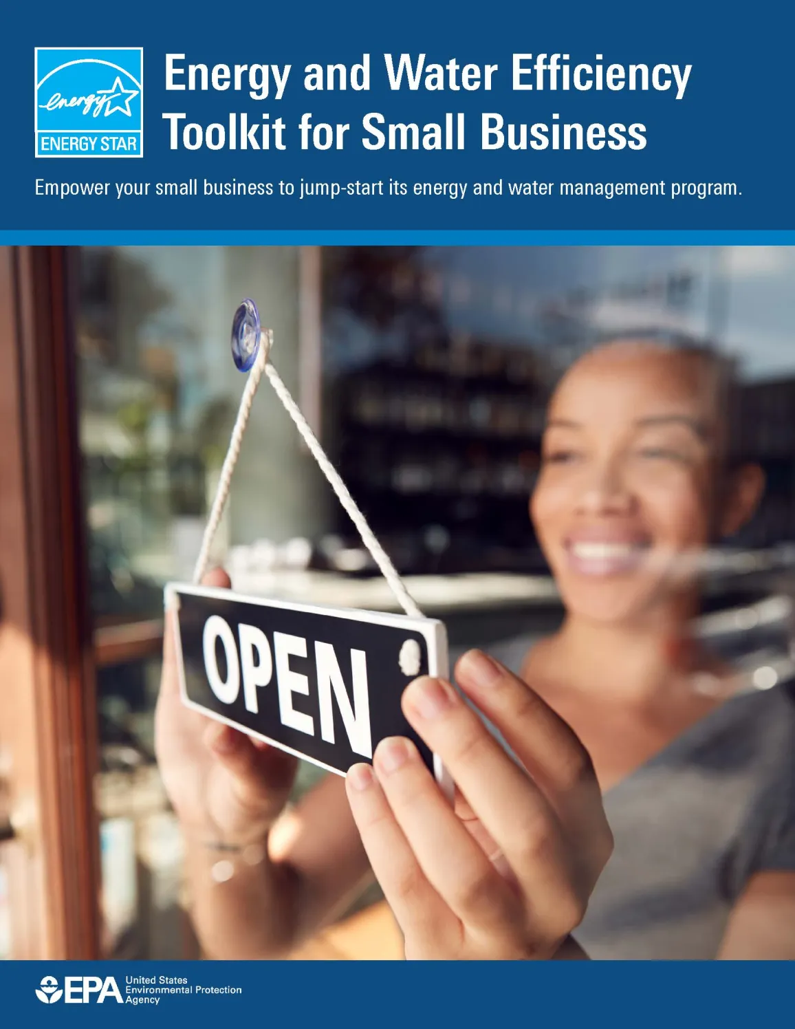 Woman hanging open sign on glass door